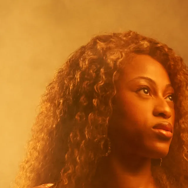 Princess Wonda in close-up, lit through smoke.